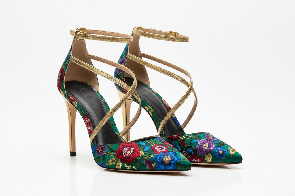Women's emerald green floral embroidered stiletto heels with gold accents on white background